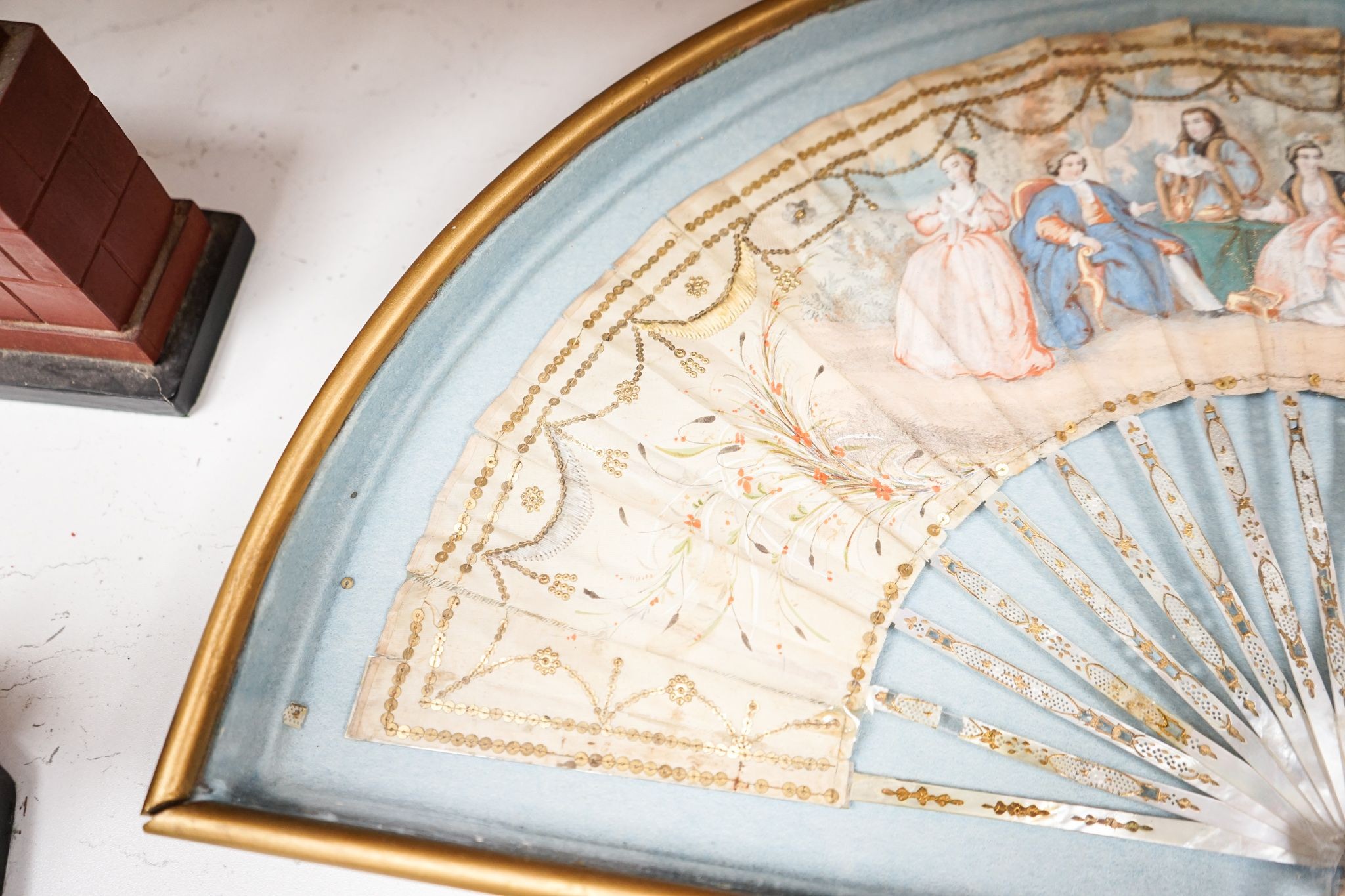 A late 18th / early 19th century Continental figurative framed fan and two religious cased effigy of baby Jesus